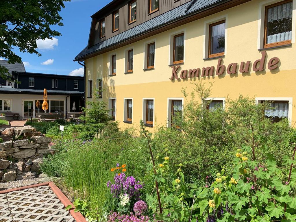 a garden in front of a building with the word komondoria at Hotel Dachsbaude & Kammbaude in Seiffen