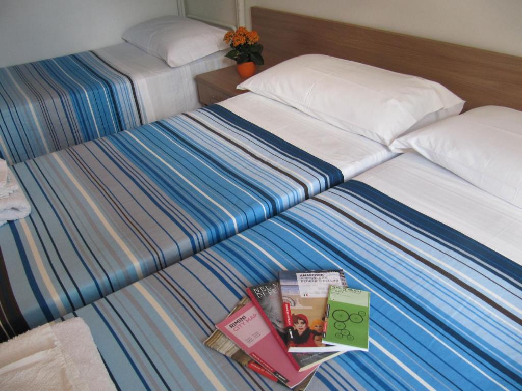 Postel nebo postele na pokoji v ubytování Hotel Villa Elia