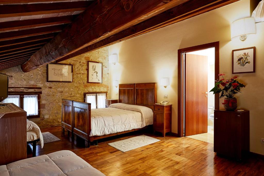Łóżko lub łóżka w pokoju w obiekcie Agriturismo Le Vescovane