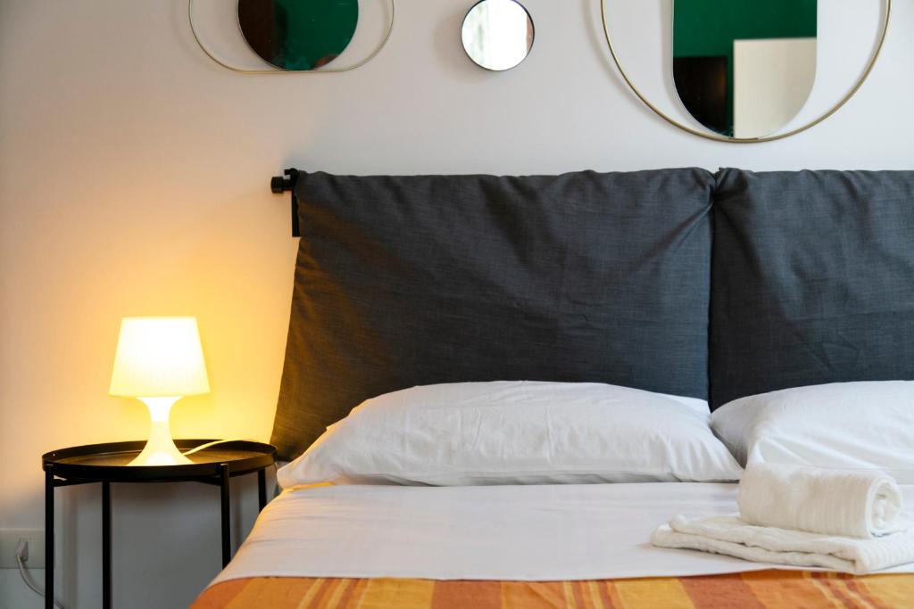 a bedroom with a bed with a lamp and a mirror at Monolocale il Tindaro in Catania