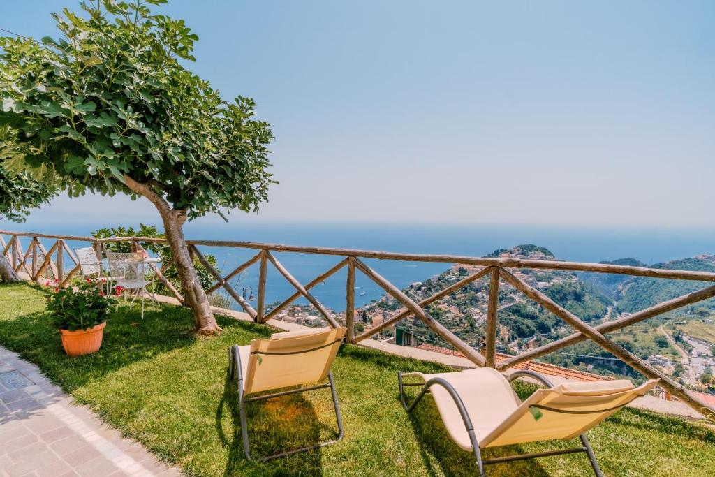 a couple of chairs sitting on top of a hill at Monte Brusara Relais in Ravello
