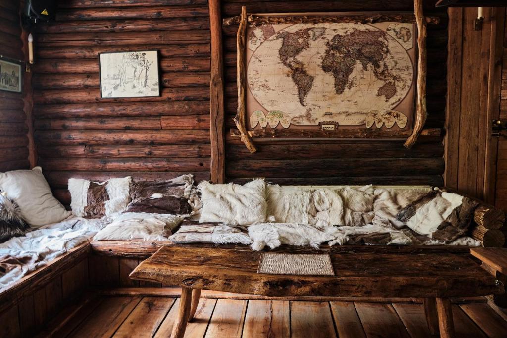 a couch in a room with a map on the wall at Golema Reka in Crni Vrh