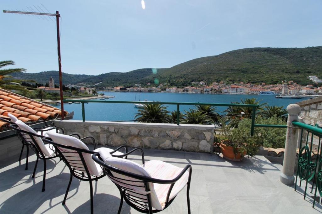 a patio with chairs and a view of the water at Apartment Karlo Vis in Vis