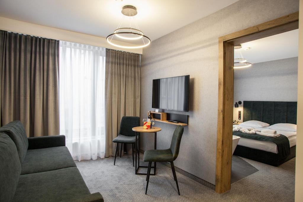 a hotel room with a couch and a bed at Hotel Alexander in Krakow