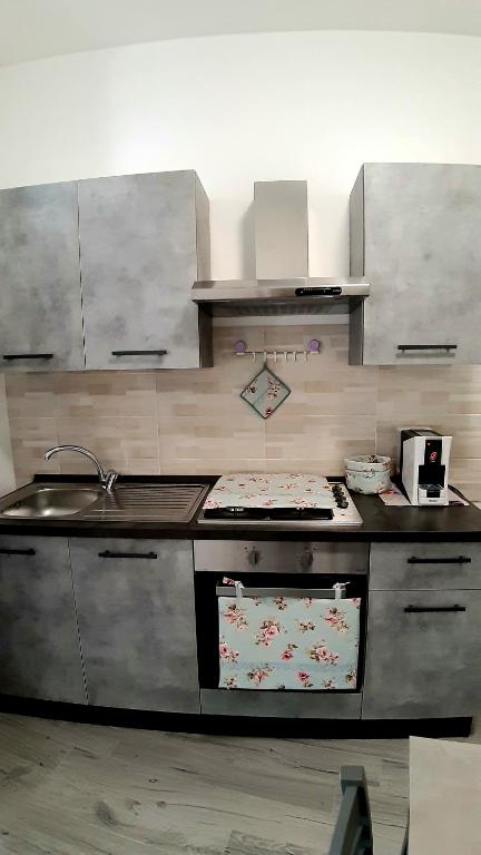 a kitchen with a sink and a stove top oven at Casa vacanza Viola in Trapani