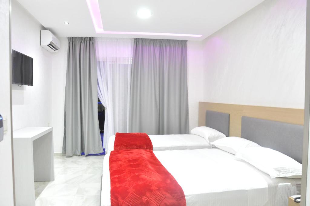 Postel nebo postele na pokoji v ubytování Hôtel laluna bay