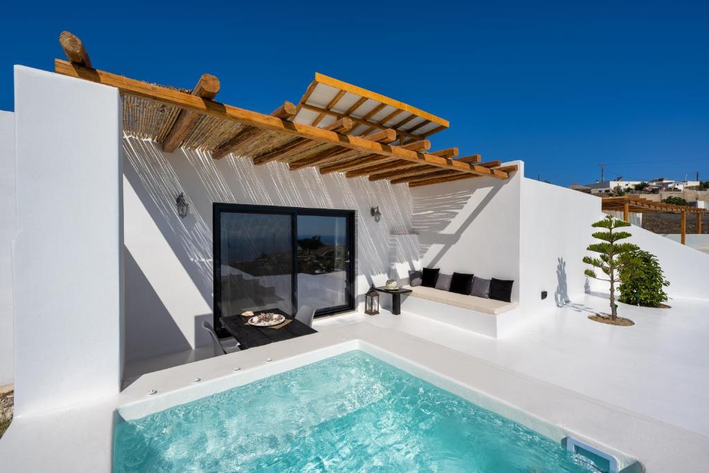 a swimming pool in the backyard of a house at Abrazo Villas in Imerovigli