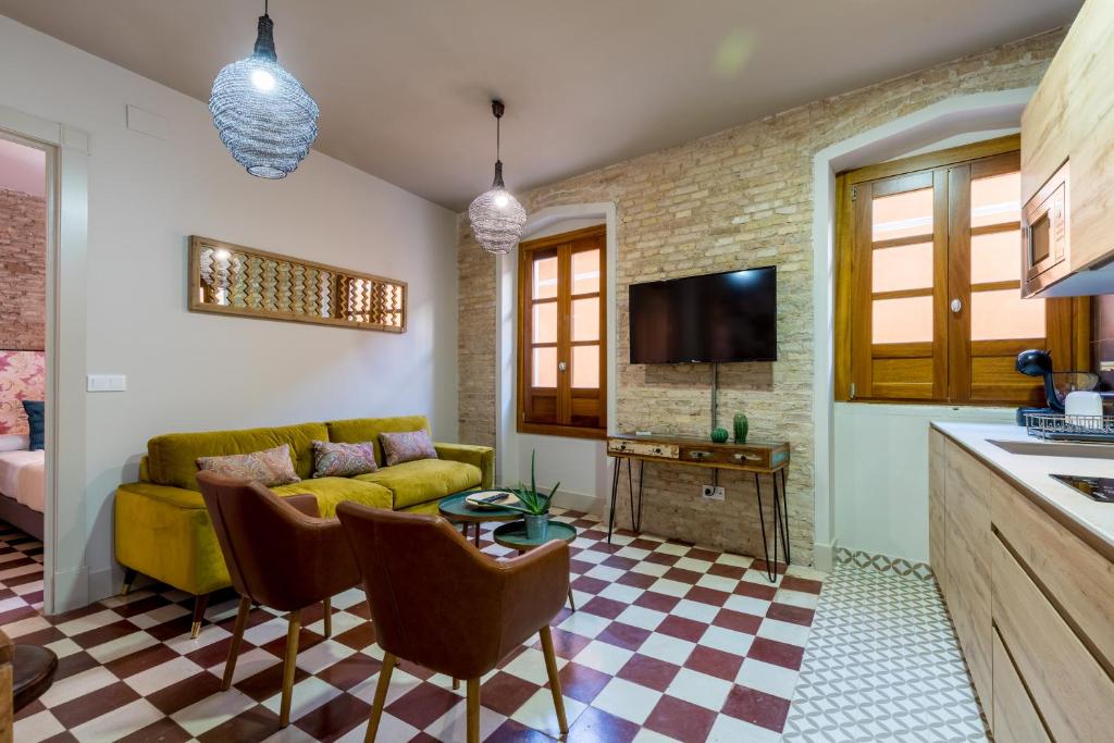 a living room with a couch and a table at Doña Elvira Suites Cathedral in Seville