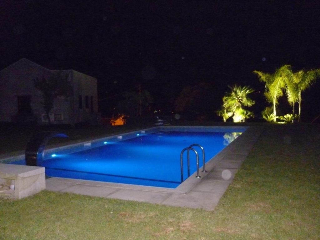 a swimming pool in a yard at night at Quinta de Santa Marinha in Arcos de Valdevez