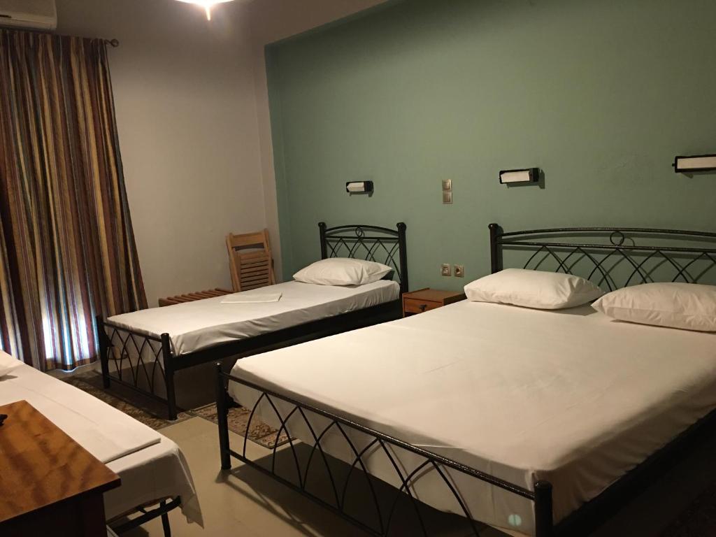 A bed or beds in a room at Artemis