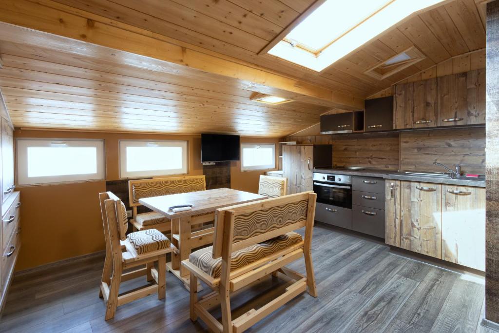 a kitchen with a table and chairs in a room at BOLERO Suites in Varna City