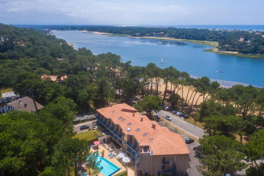 an aerial view of a resort and a lake at Hotel Logis Lacotel in Hossegor