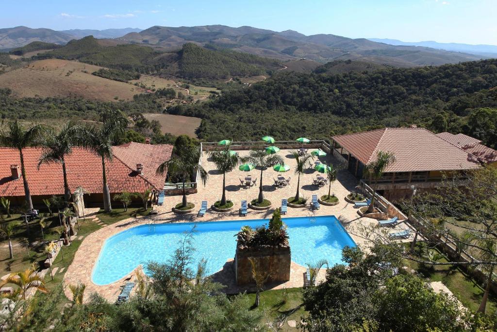 an aerial view of a resort with a swimming pool at Hotel Alpha Ville Chalés in Conceição da Ibitipoca