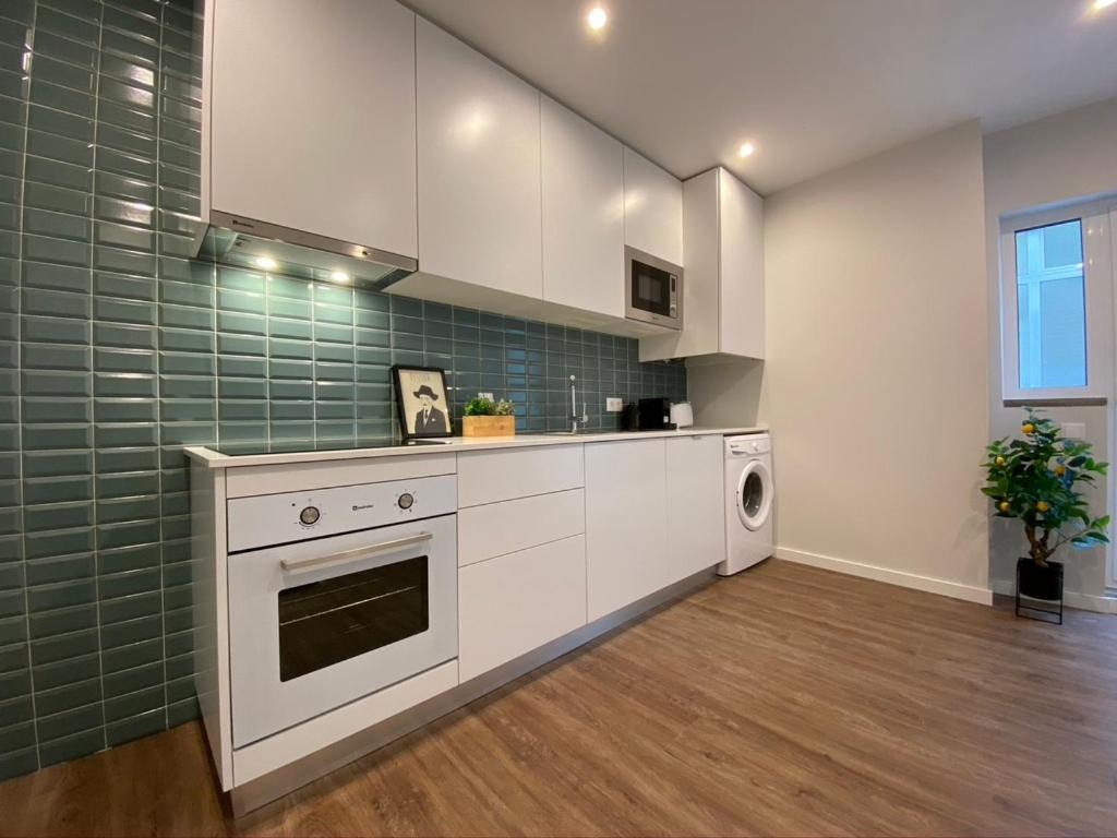 a kitchen with white appliances and green tiles at Santuário Fátima - Host 2AP5 in Fátima