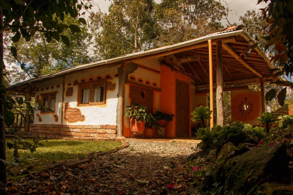 ein kleines Haus mit Orange und Weiß in der Unterkunft Hospedaje Solentiname in Medellín