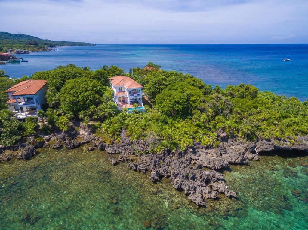 an aerial view of a house on an island in the ocean at Coral Vista #5 Home in Roatan