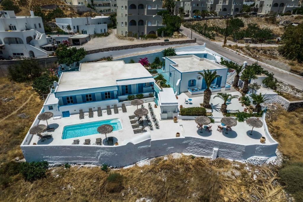 an aerial view of a house with a swimming pool at Ancient Thera Apartments in Kamari