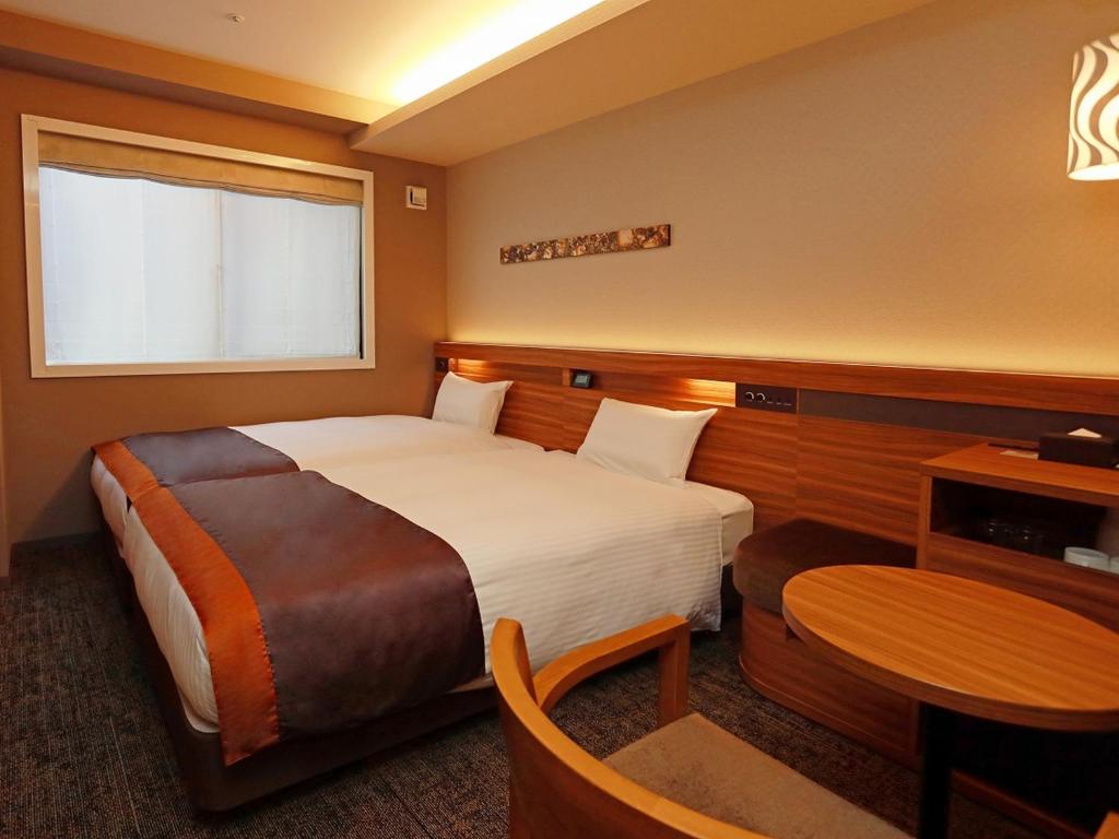 Postel nebo postele na pokoji v ubytování Urban Hotel Kyoto Shijo Premium