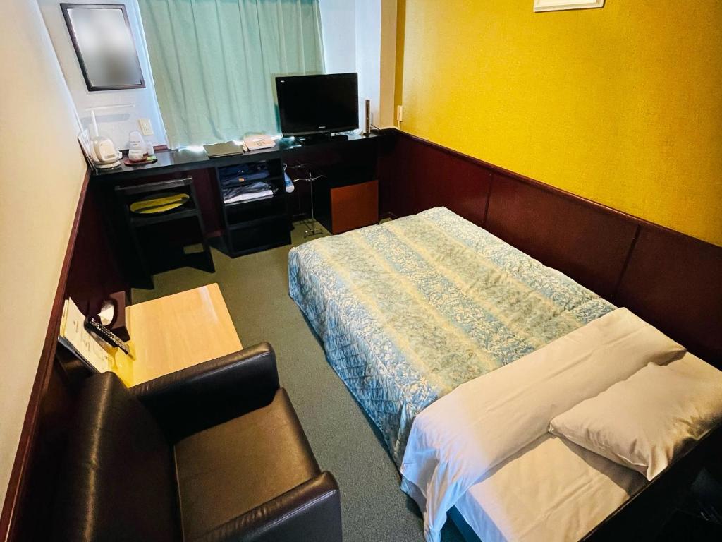 Ein Bett oder Betten in einem Zimmer der Unterkunft Shinmaebashi Station Hotel