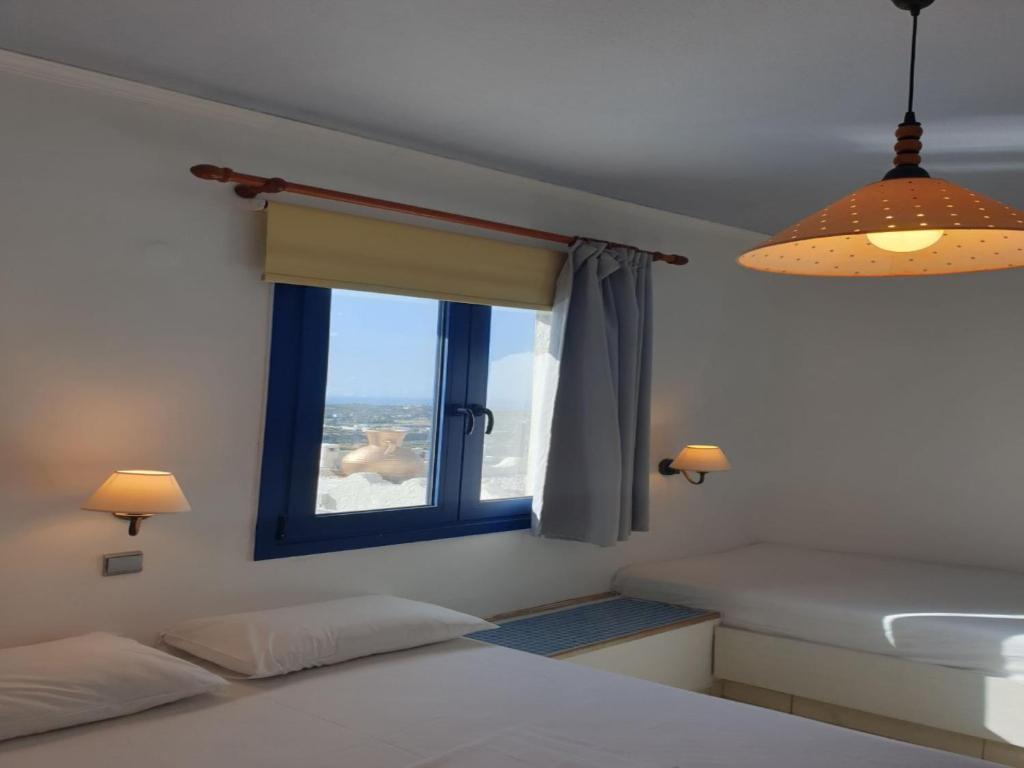 a bedroom with a window with a view of the ocean at Room in Studio - Suite 21 full view Adults Only in Hersonissos