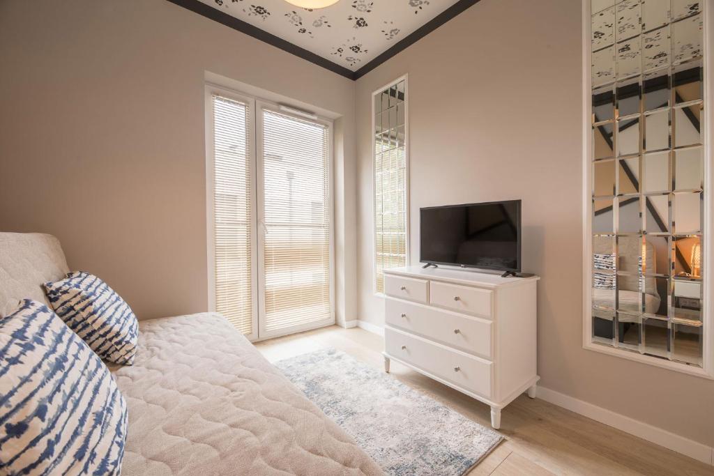 Televízia a/alebo spoločenská miestnosť v ubytovaní Apartament Mimbelli