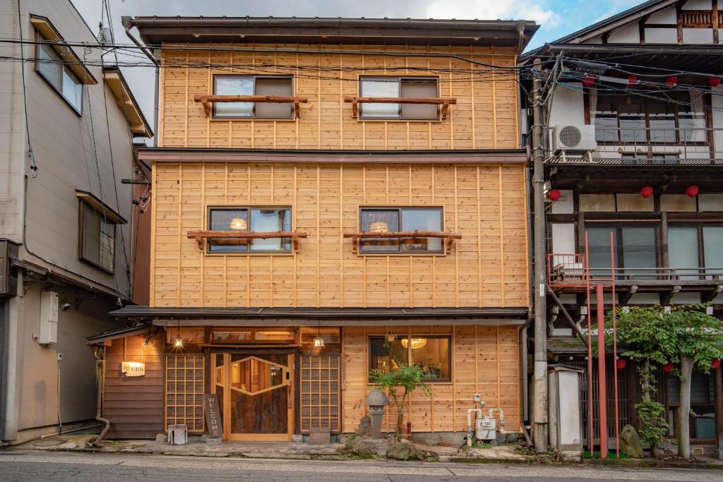 a brick building with windows on a street at AIBIYA in Yamanouchi