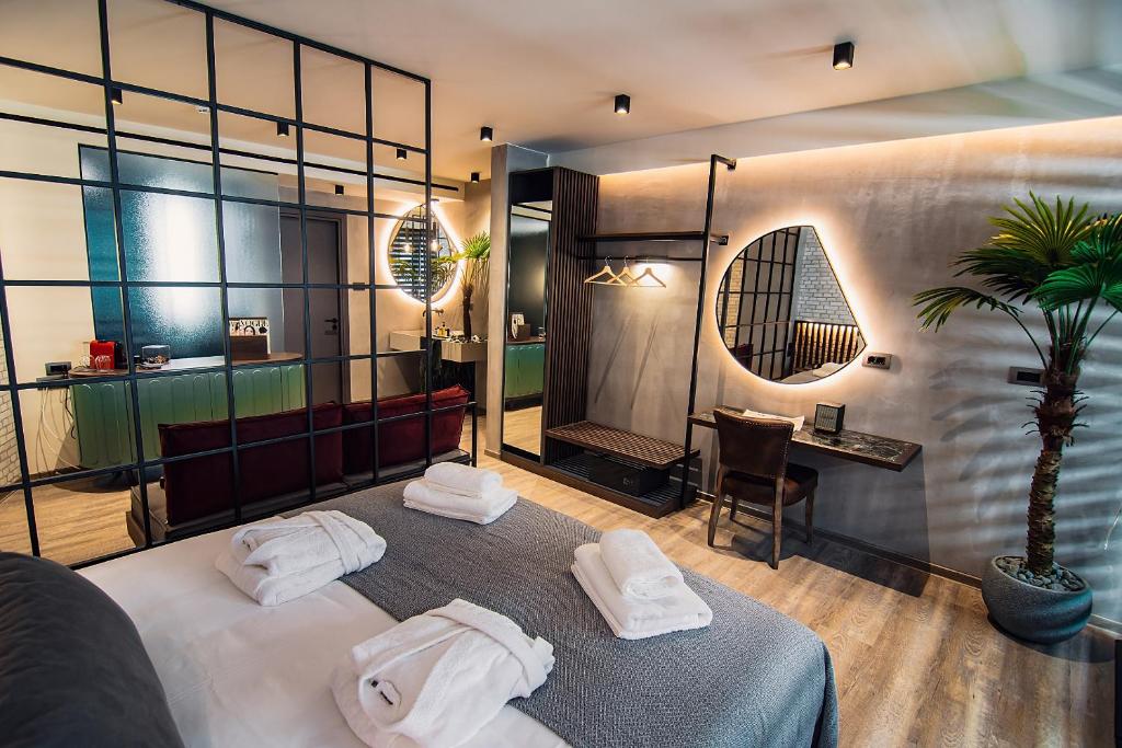a room with a bed with towels on it at Project 3 Urban Chic Hotel in Athens