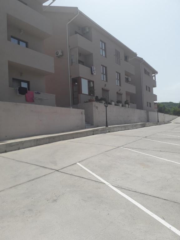 an empty parking lot in front of a building at Jovan Vukovic in Kotor