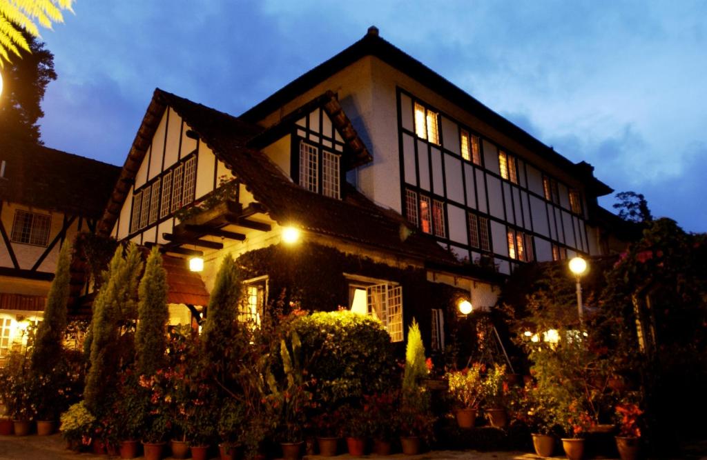 a large building with plants in front of it at The Smokehouse Hotel & Restaurant Cameron Highlands in Cameron Highlands