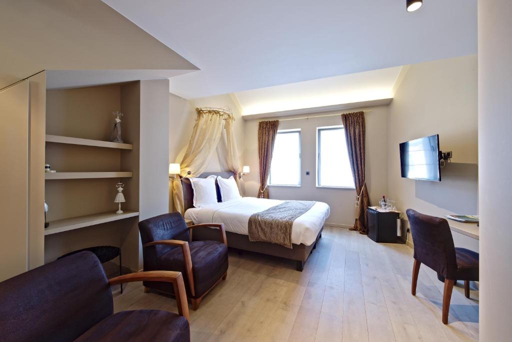 Postel nebo postele na pokoji v ubytování Hotel Saint-Amour