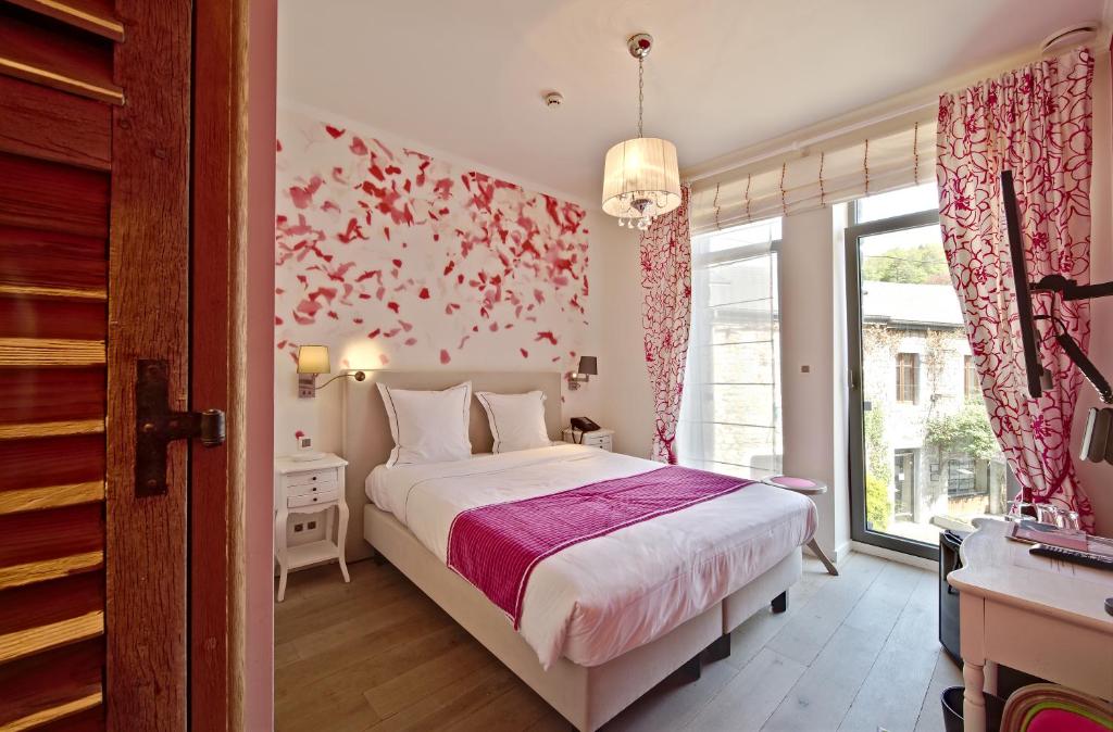Postel nebo postele na pokoji v ubytování Hotel Saint-Amour