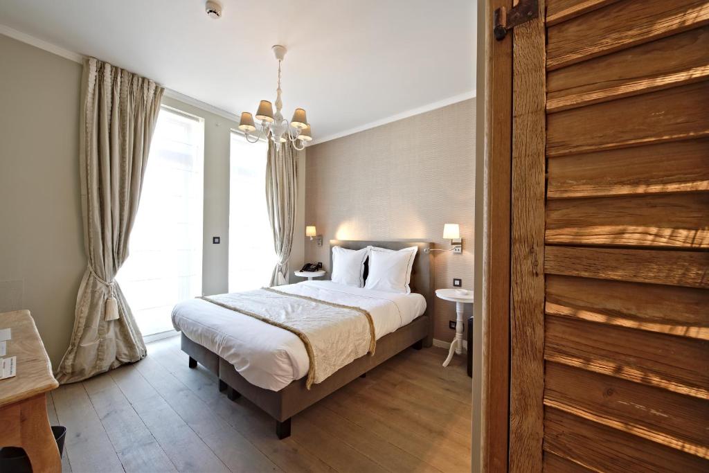 Postel nebo postele na pokoji v ubytování Hotel Saint-Amour