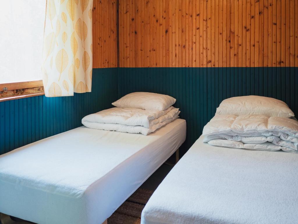 Postel nebo postele na pokoji v ubytování Pustelnia Supraśl - domki nad rzeką
