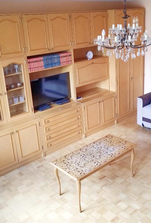a living room with wooden cabinets and a coffee table at Apartment PER DAY in Vrbas