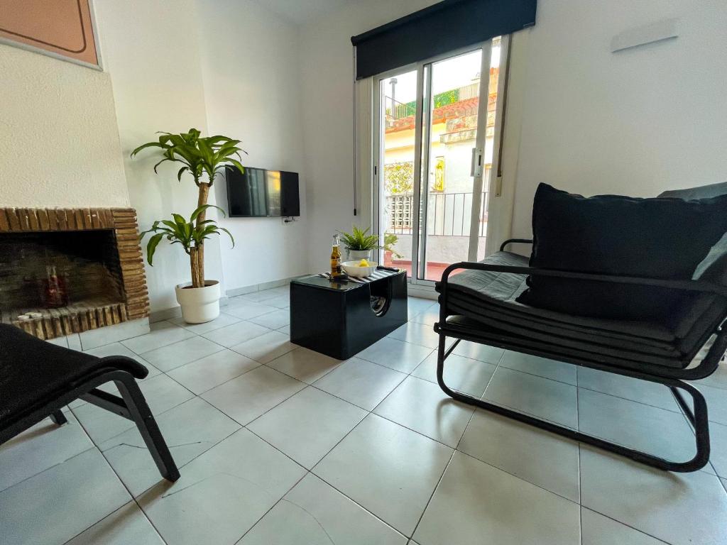 Televízia a/alebo spoločenská miestnosť v ubytovaní Tossa Center Attic & Terrace