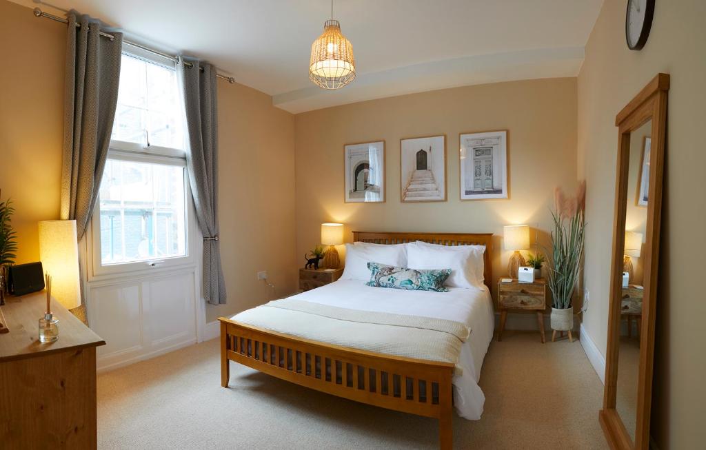 a bedroom with a large bed and a window at Marine Sands - luxury apartment in Scarborough