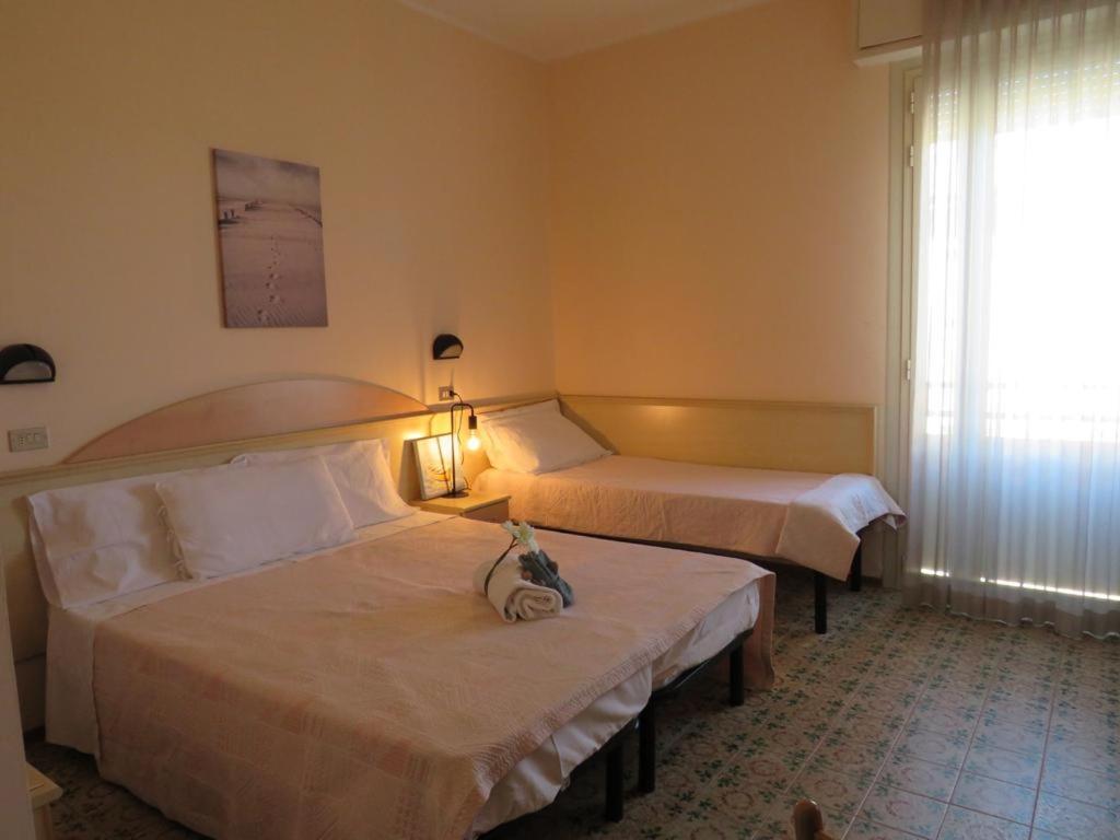 Postel nebo postele na pokoji v ubytování Hotel Primula