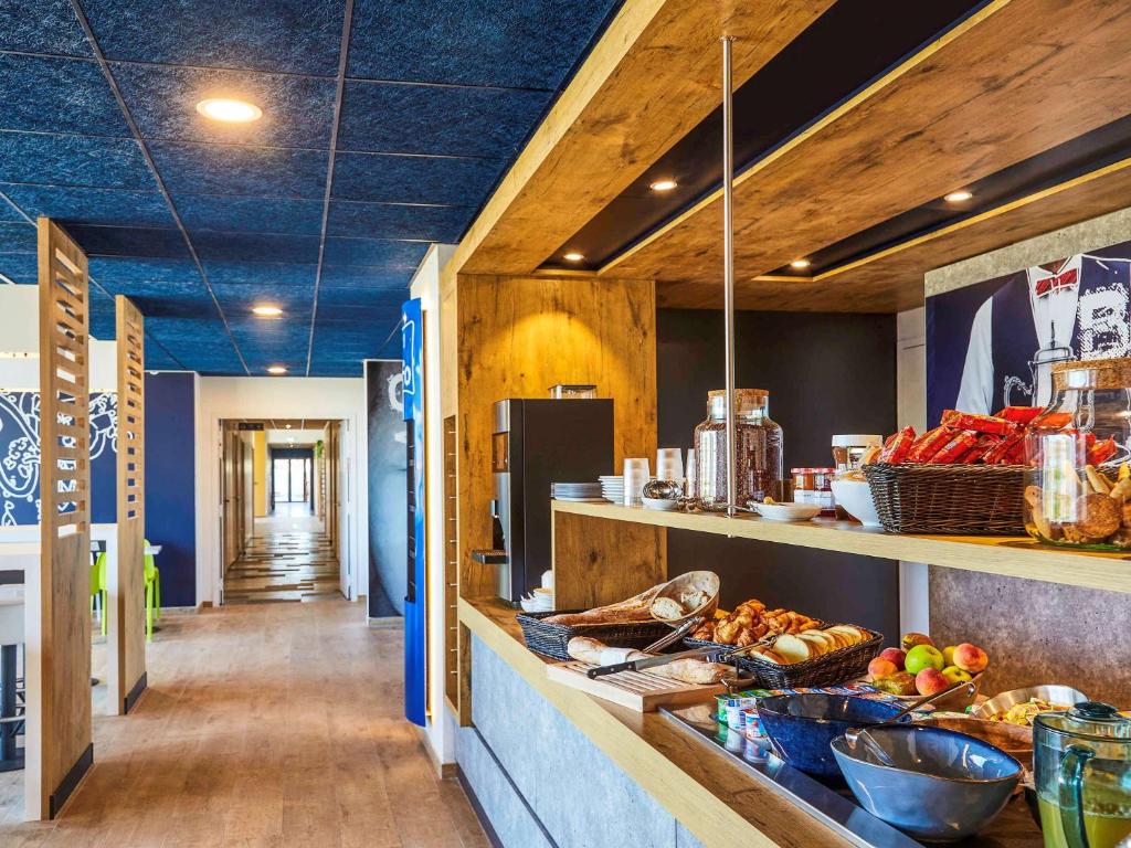 a kitchen with a counter with food on it at Ibis Budget Montpellier Aéroport Parc Des Expos in Mauguio