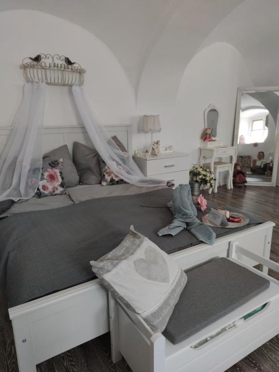 a white bed with a canopy in a bedroom at Korona Apartman Székesfehérvár in Székesfehérvár