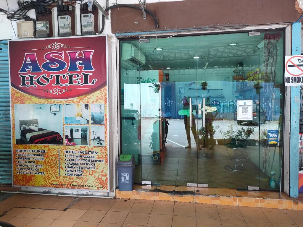 a store window with a sign on the front of it at ASH HOTEL in Seremban