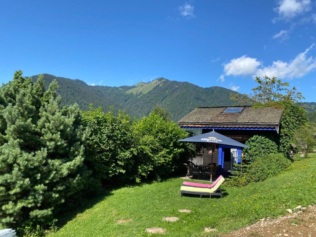 a gazebo with an umbrella on a hill at Micro-lodge, Le Petit Nid d'Amour in Montriond