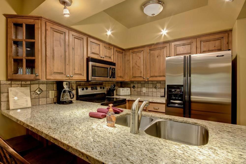 a kitchen with a sink and a refrigerator at Empire Coalition #106 in Park City