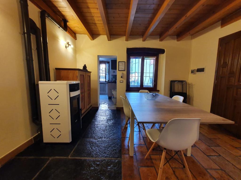 a kitchen with a large wooden table and chairs at I Scalitt by Quokka 360 - Typical Lake Como House in Carate Urio