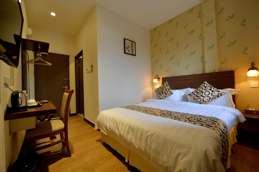 Postel nebo postele na pokoji v ubytování Asiana Hotel