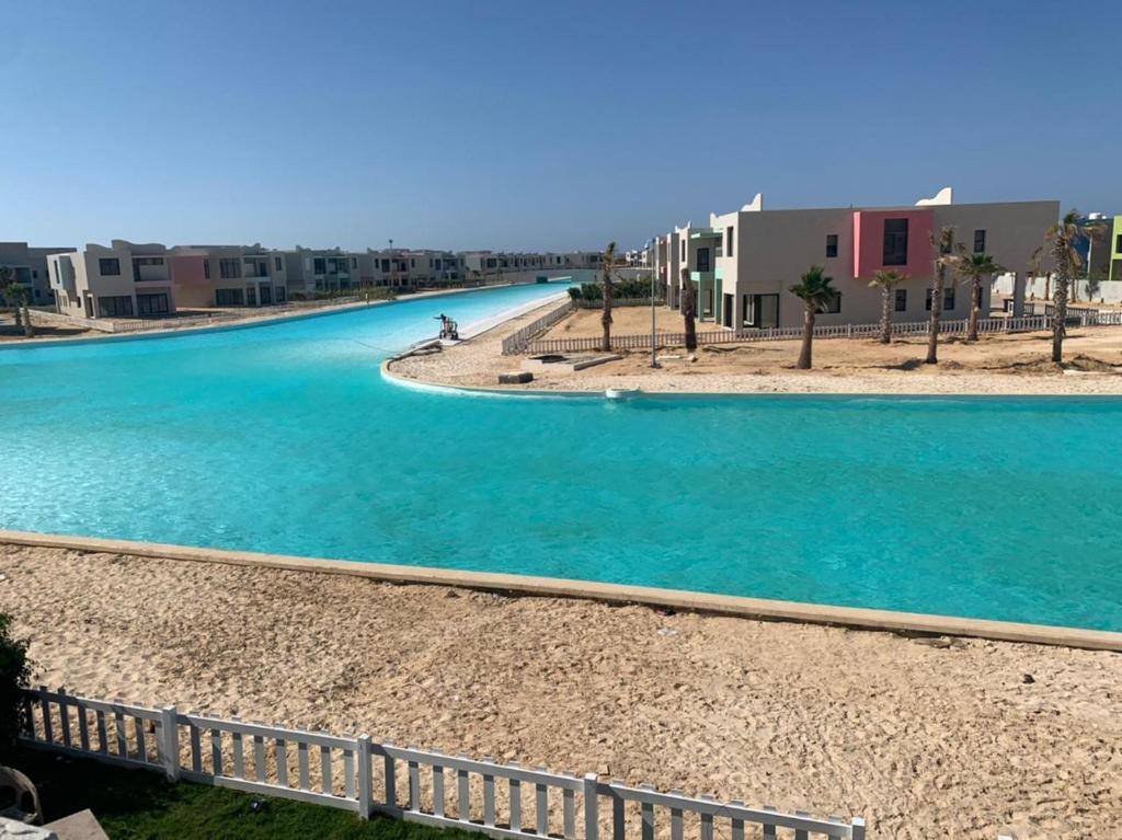 a pool of water with buildings in the background at Bo Islands villa in El Alamein