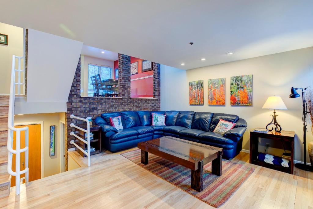 a living room with a blue couch and a table at Sun Spot in Deer Valley in Park City