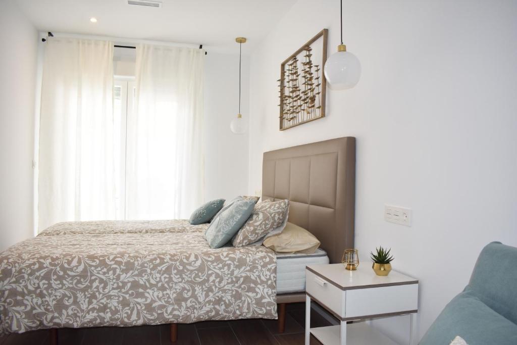 a bedroom with a bed and a couch at APARTAMENTO ABUELA PILAR in Caparroso