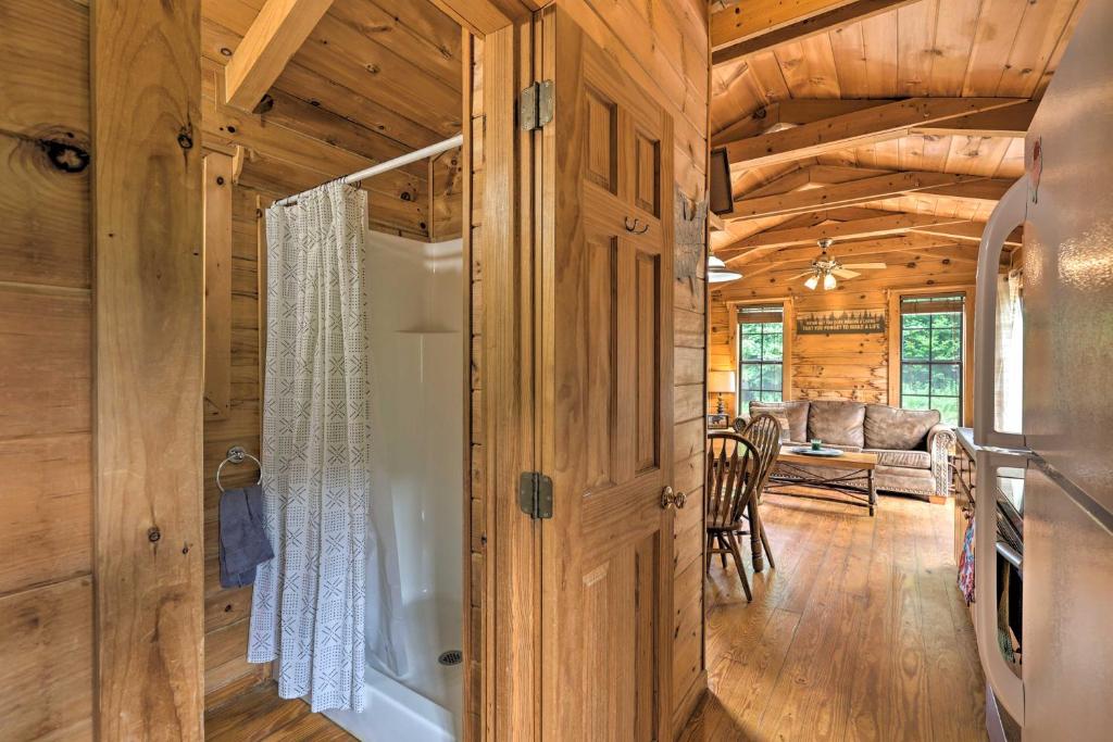 a door leading to a living room in a log cabin at Quaint Log Cabin with Views Near West Jefferson in Warrensville