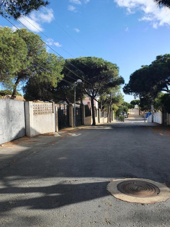 an empty street with a man hole in the middle of the road at PINO BEACH in Punta Umbría