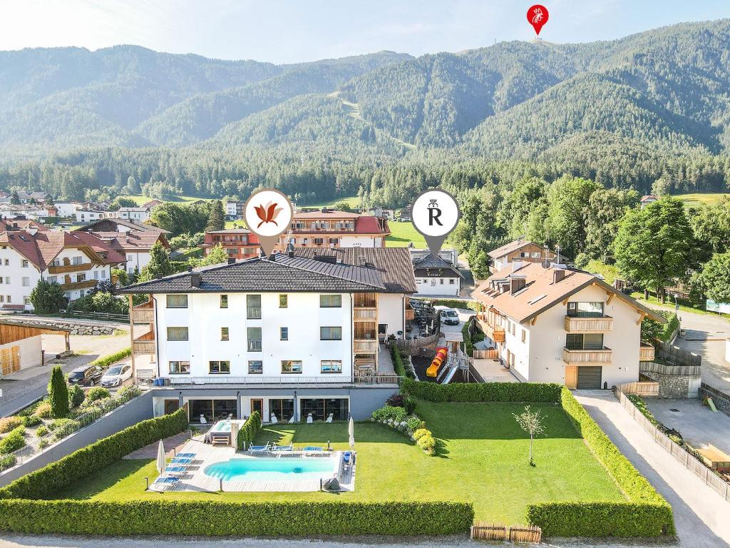 an aerial view of a house with a swimming pool at Hotel B&B Feldmessner in Brunico